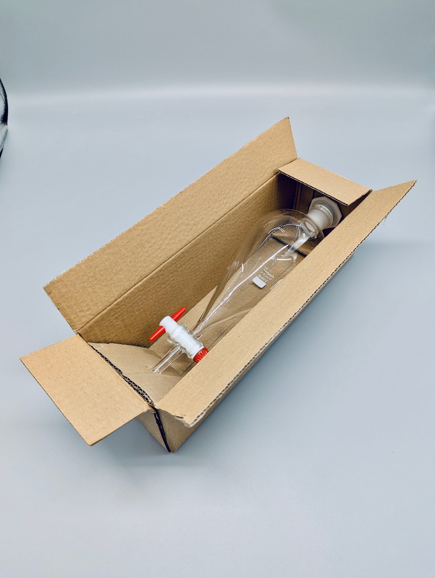 Separatory funnel with PTFE stopcock and plastic stopper